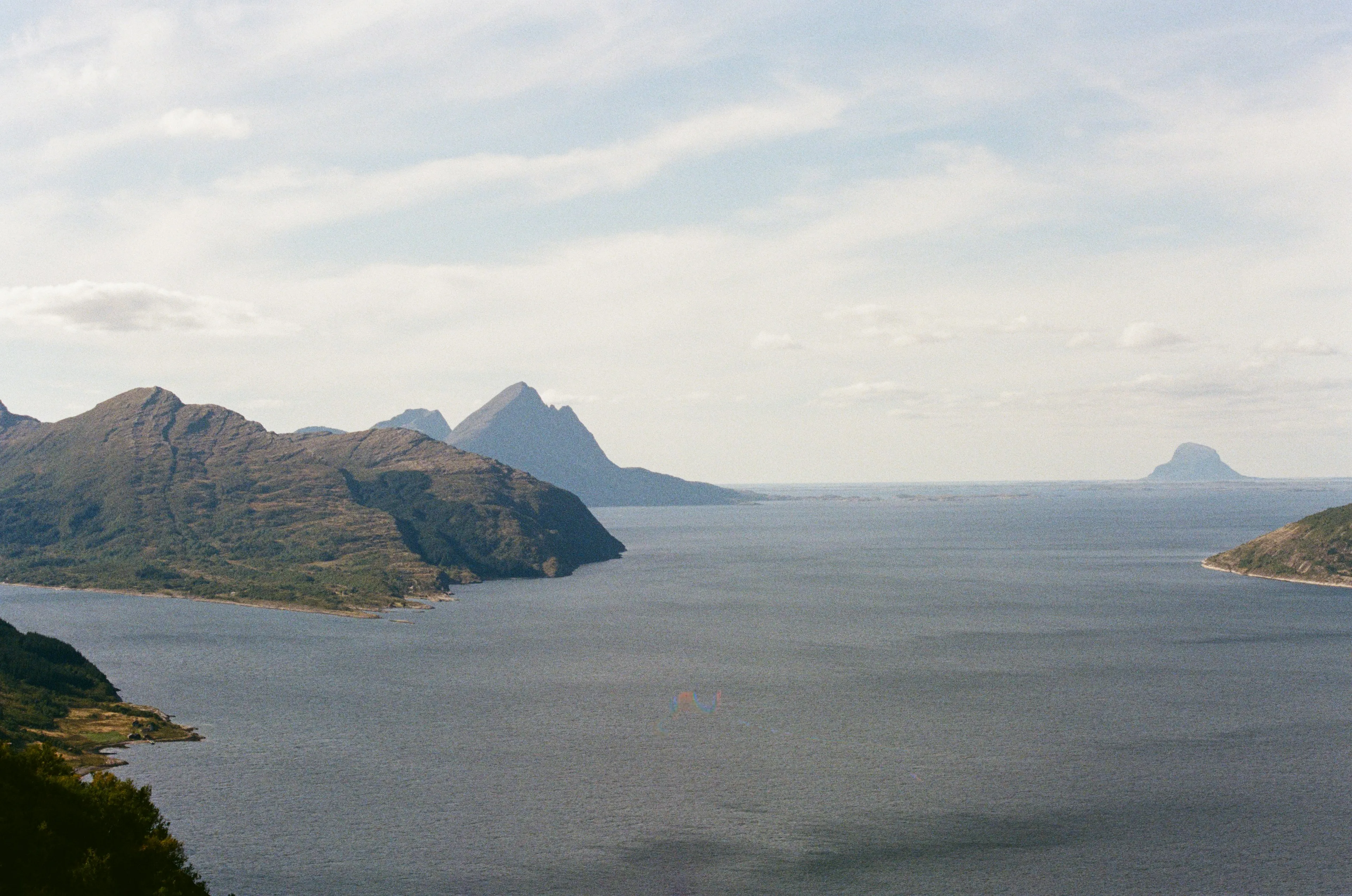 Norwegian fjord with mountains rising above calm water
